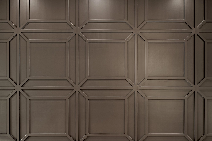 brown wall with custom millwork in a patterned square design
