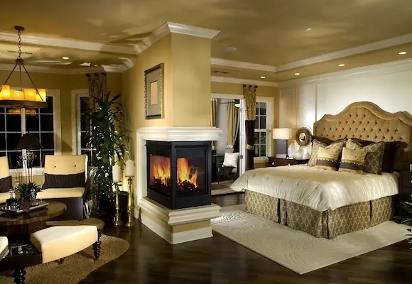 luxury master bedroom with gas fireplace and custom trim molding