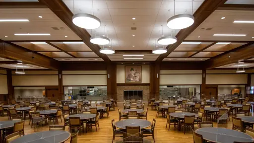 a large dining room with tables and chairs