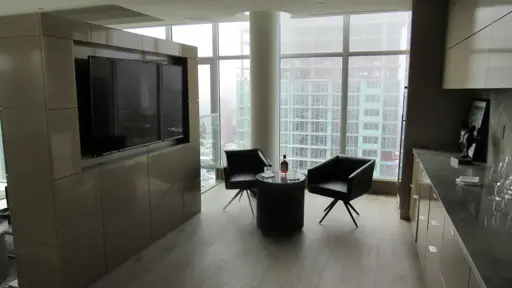 a television on the wall coffee table and cabinets