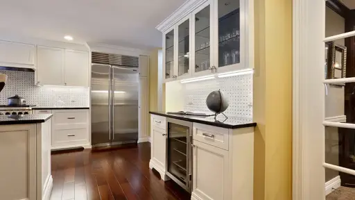 a kitchen with white cabinets and stainless steel appliances