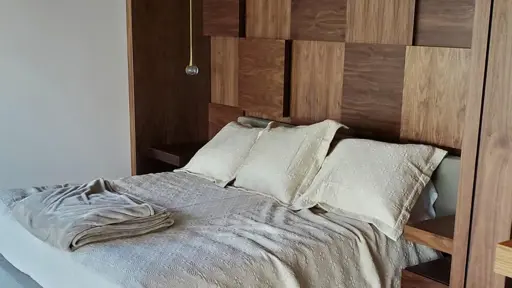 a bed with three pillows