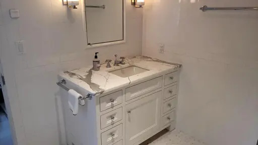 a white marble bathroom sink