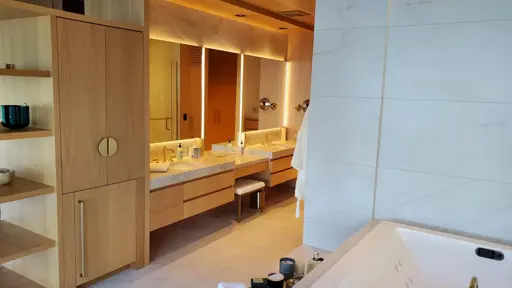 a bathroom with a bathtub, sink and mirror