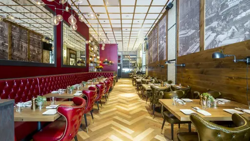 a restaurant with red and gold retro chairs