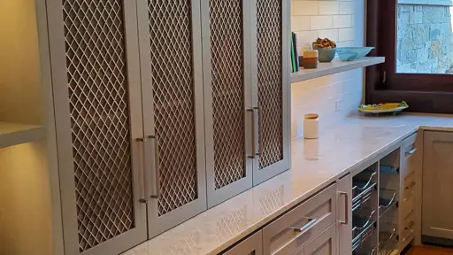 a kitchen with stainless steel cabinets and a window