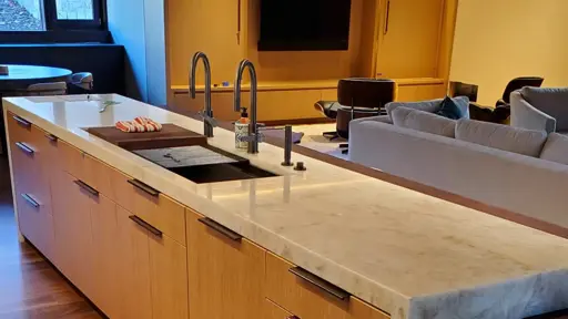 a kitchen with white marble counter