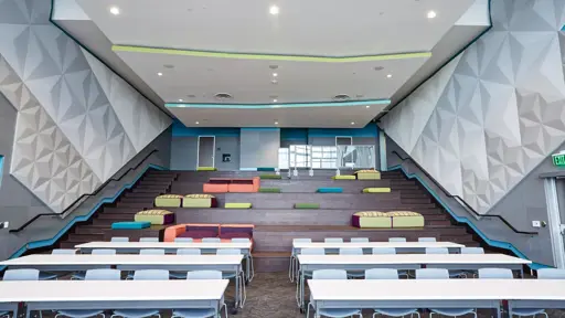 a conference room with tables and chairs in it