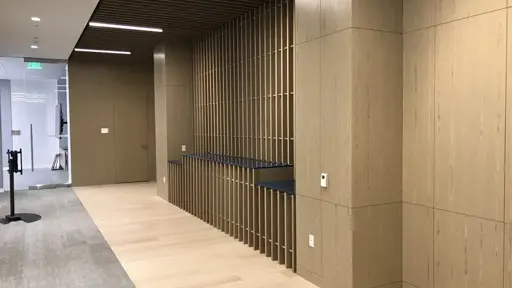 a hallway in an office with wood paneling