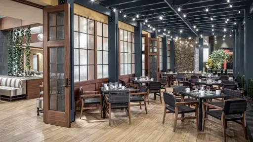 a restaurant with gray ceiling and gray chairs